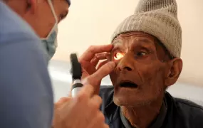 Dr. Carey Dozier does a preliminary examination of a patient at an eye camp supported by the Druk Amitaba Monastery in Sitapaila, Kathmandu