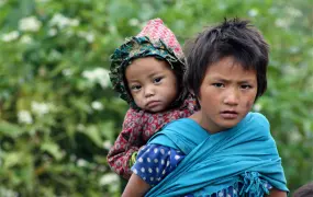 Children make their way from one village to the next in Jumla District, Karnali Zone. Girls largely miss out on education, marry young and have children young. Nearly a quarter of Nepalese women have their first child before they are 18 and more than half