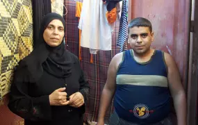 Shahrazad AbuThuria, 41-years old from Gaza City, and her 16-year old son Belal, who is mentally disabled. She and her six children live in a two-room garage without insulation.  As a refugee Shahrazad receives food assistance from the UN Relief and Works