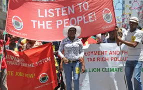 Protestors from the Democratic Left Front join thousands of other activists on the Global Day of Action in Durban