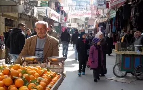 Palestinian man selling oranges in the Old City of Nablus. Despite some economic growth reported in the West Bank in 2011, purchasing power remains low. Unemployment in the West Bank hovers at 24 percent, according to the UN