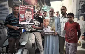 Egyptian voters holding up posters of the two presedential candidates in Cairo on June 16 2012