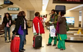 Congolese family arrives at an airport in Spokane, US, and are greeted by their caseworker and volunteers