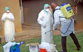 Doctor Yab Boun disinfecting colleagues before they investigate suspected Ebola cases at a new isolation centre at Mbarara Referral Hospital, south of the affected Kibaale district in western Uganda