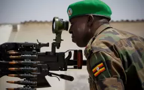 A Ugandan officer serving with the African Union Mission in Somalia (AMISOM) ranges a scope on a heavy machine-gun mounted on the roof of Mogadishu University 23 January. AMSIOM and Somali National Army (SNA) forces have consolidated newly captured positi