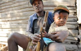 Love, a community hired security guard, with his young child in Bevilany, in south east Madagascar