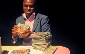 Congolese ethnologist displays a recently-released CD he produced of songs sung by the indigenous Baka community