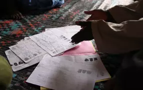 Aliou Moussa So, head of a refugee community of 73 families in PK 6 village, 6km from Rosso, shows IRIN paperwork of returnees who have still not attained their ID cards after 4 years of trying