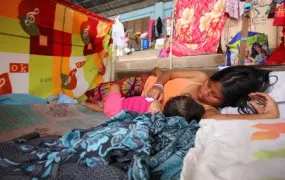 A young mother nurses her child at a shelter in Mindanao, which was badly affected by Typhoon Bopha in December 2012. More than 6.2 million people were affected