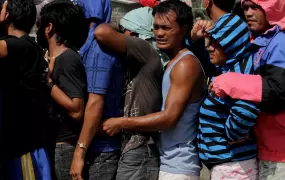 Compostela Valley, Philippines - Men crowd each other as they queue for food relief in a southern Philippine ravaged by typhoon Bopha