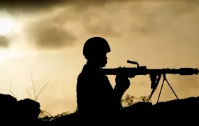 A Ugandan soldier serving with the African Union Mission in Somalia (AMISOM) holds a rocket-propelled grenade at sunrise, on the frontline in Maslah Town, on the northern city limit of Mogadishu