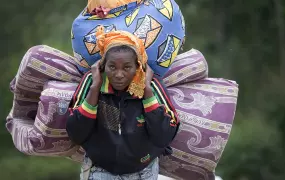 A woman IDP arrives in Munigi as Bosco Ntaganda fighter approach from goma, the 1st of March 2013