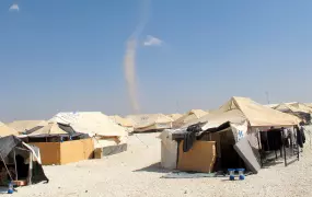 A whirlwhind approaches Za’atari camp for Syrian refugees in the northern Jordanian desert. Poor protection from the elements has led to riots in the camp