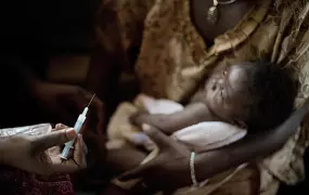 Central African Republic, 2011: A health worker prepares to vaccinate a baby boy in a clinic in Bangui