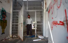 Former inmate on a return visit to his cell at Tripoli’s Abu Salim prison where he was held for several years. October 2011