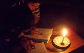 Yusri and his brother find it very exhausting to read with candle light