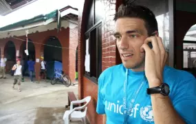 A UNICEF staff member speaking on his phone at the UN operations centre in Tacloban, one of the areas worst affected by Typhoon Haiyan, which struck the central Philippines on 8 November. Getting mobile networks up and running after a disaster are key in 