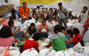 Local aid workers have worked tirelessly for hours in repacking goods for the thousands of affected families in Tacloban City in the aftermath of Typhoon Haiyan, which struck the central Philippines on 8 November 2013