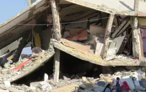 Women and a child sit in the shade amid the rubble of a home in Rafah town in Egypt's North Sinai governorate. The building was destroyed in October during the security forces' counter-terrorism campaign against militants. (Photo taken by Sophie Anmuth in