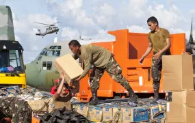 Members of the Philippine military load relief goods at Tacloban's airport