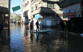 Crews use boats to rescue people stranded by flood waters in Gaza City's Zeitoun area after heavy rains from 11-15 December 2013. (Photo taken on 15 December)