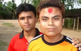 Two Bhutanese young men look to the camera at a refugee camp in eastern Nepal. Since late 2007, more than 86,000 Bhutanese refugees have received third country resettlement