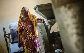 Guindo Tembely, director of the NGO, YAGTU, stands behind machinery used to make Farine, a protein rich dietary supplement given to women and children in Mali's Mopti region.