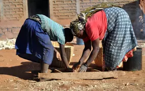 Verdiana Msuya and her daughter  sieving cereals to remove soil/impurities  at her home in  Mangio village, Mwanga district, Tanzania February 2014. This district is frequently hit by drought thus affecting livelihoods of most people 