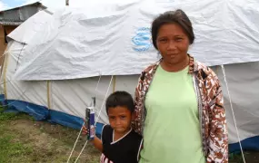 Arlyn Redona, 32 and her son Michael, 5, outside their tent six months after Typhoon Haiyan struck. More than 2 million remain without adequate shelter six months after the category 5 storm stuck on 8 November, 2013