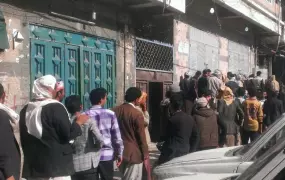 Yemenis queue to buy flour and wheat in Sana'a on April 1, 2015