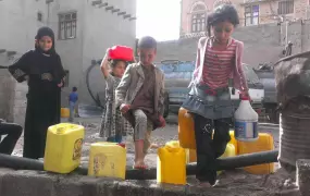 Yemeni children carry water from their local mosque in the capital Sana'a. A Saudi Arabian-led coalition began a bombing campaign against the Houthi rebels in Yemen three weeks ago