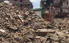 A man walks on top of debris from collapsed monuments in Basantapur in Central Kathmandu on 27 April 2015 in Kathmandu, Nepal. Nepal was struck by a powerful earthquake on 25 April 