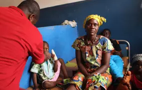 Doctor Kalissa N’Fansoumane (in red) sees patients at a hospital in Gueckedou in April 2015