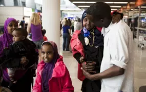 Mohad, a Somali refugee, reunites with his wife and children at Warsaw airport in Poland after five years apart