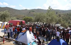 Non syrian refugees jostle for food at a volunteer distribution in Moria camp, Lesbos. Many have spent all their money getting to Greece and have no cash even for basics such as food.