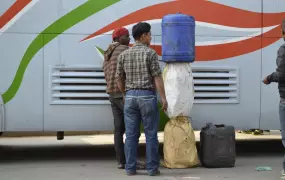 Men in Nepal's capital, Kathmandu, unload fuel smuggled over the border from India on a bus in January 2016