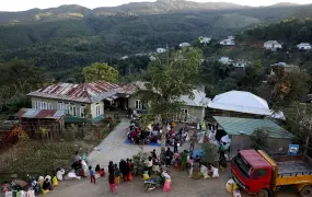 People who fled from Myanmar collect donated clothes at a temporary distribution centre at Farkawn village near the India-Myanmar border, in the northeastern state of Mizoram, India, 20 November 2021.