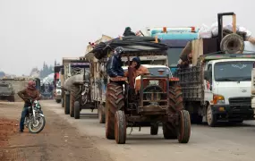 Trucks carry belongings of people fleeing from Maarat al-Numan, in northern Idlib, Syria 24 December 2019.