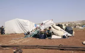 A child sits in a makeshift camp.