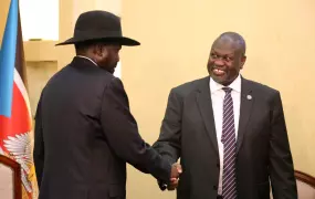 South Sudan's President Salva Kiir shakes hands with Riek Machar, ex-vice president and former rebel leader, during their meeting at the State House in Juba.