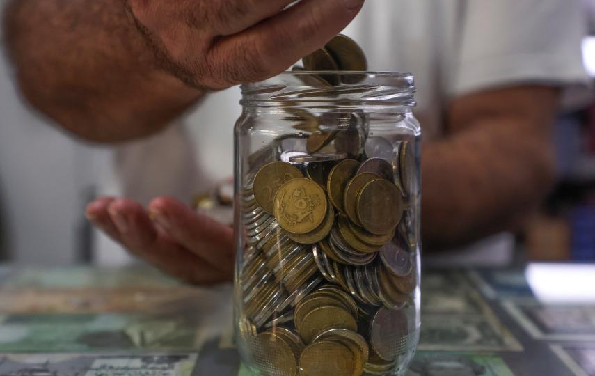 A jar of 250 and 500 Lebanese lira coins at a grocery store in Beirut. The currency has lost so much value the coins are now almost useless.