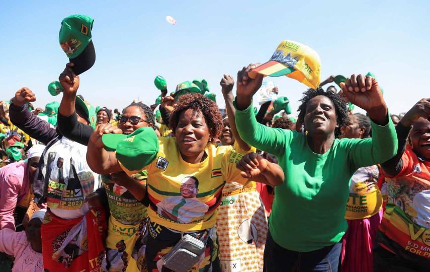 Picture of supporters of Zimbabwe’s President Emmerson Mnangagwa cheer at a rally ahead of the 2023 general elections on August 23, at Robert Gabriel Mugabe Square in Harare, Zimbabwe, August 9, 2023. Pictured at the center are women waving caps and donning clothes that are all marked as supporting President Emmerson Mnangagwa.