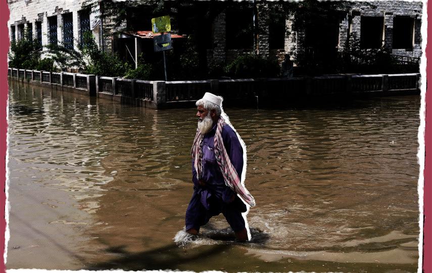 This photo shows a man walking through rain waters. The water reaches his calves. This is following rains and floods during the monsoon season in Jacobabad, Pakistan August 30, 2022.