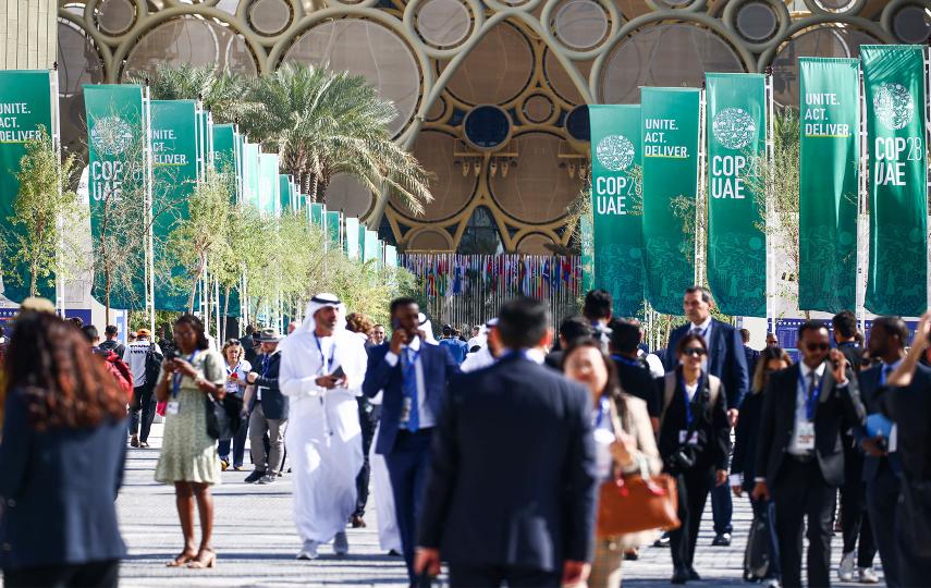 People walking around The 28th Conference of the Parties to the United Nations Framework Convention on Climate Change.