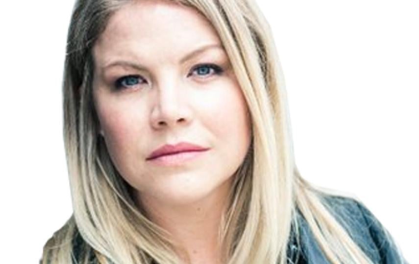 This is a headshot of Emma Beals. She looks at the camera without smiling.