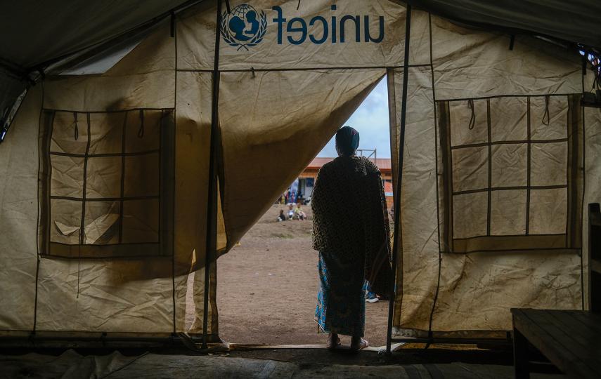 We see the silhouette of a Congolese Tutsi woman who said she was targeted by the Nyatura militia, as she stands by the entrance of a tent at the Nkamira transit centre in western Rwanda.