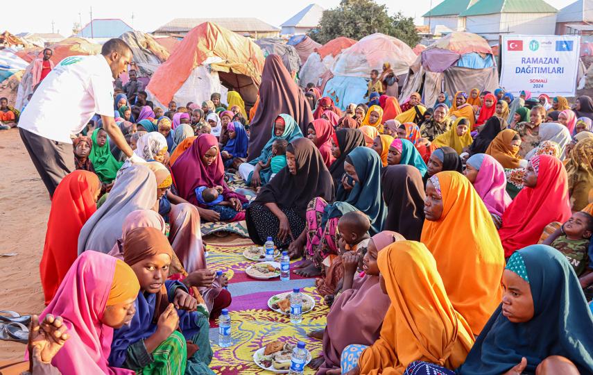 People in need living in camps in Mogadishu wait to receive iftar meal on March 22, 2024 in Somalia.