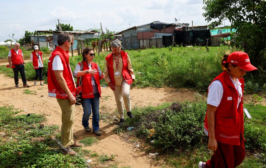 Charlotte Slente, secretary general of the Danish Refugee Council (DRC), and other DRC staff walk through a migrant neighbourhood in Riohacha, Colombia, in December 2024.