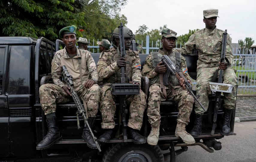 M23 rebels sit on a truck while escorting alleged captured FDLR members to Rwanda for repatriation, on 1 March 2025.
