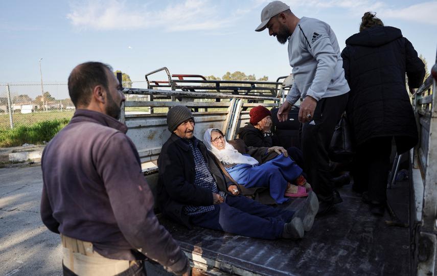 Syrian Alawite families return to their homes after seeking refuge at a Russian air base in Latakia during days of sectarian revenge killings, on 13 March 2025.
